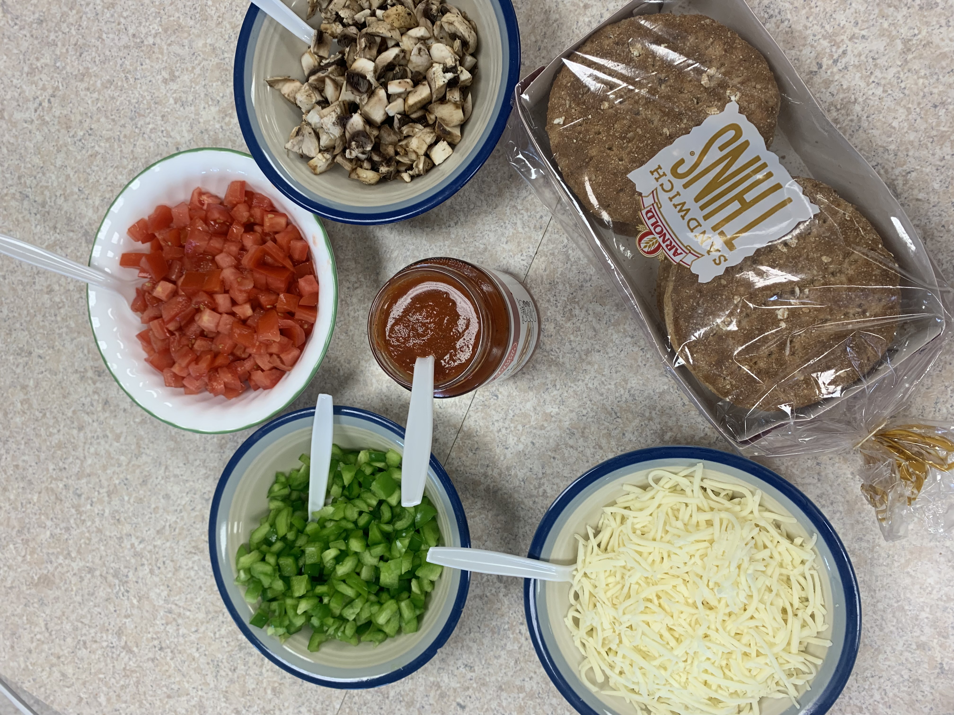 Ingredients for making pizza in bowls.