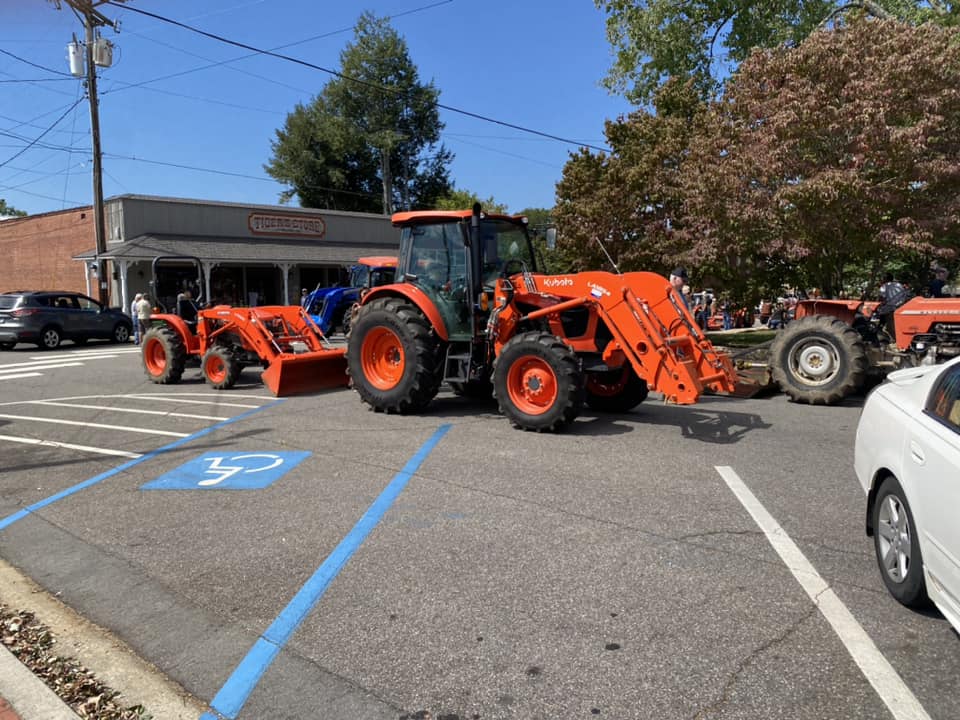large tractor in the parade followed by front loader