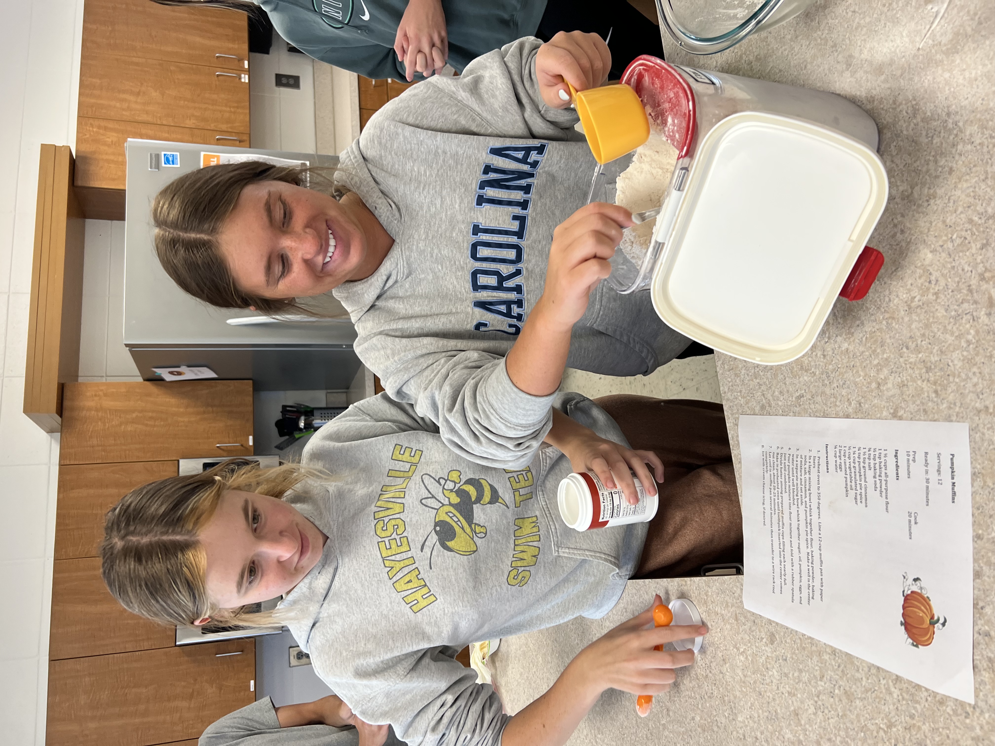 Students measure dry ingredients for use in baking.