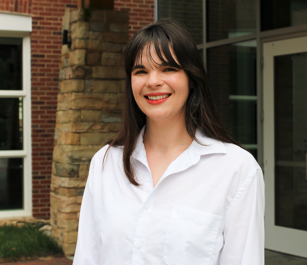 Portrait photograph of a woman in a white shirt.