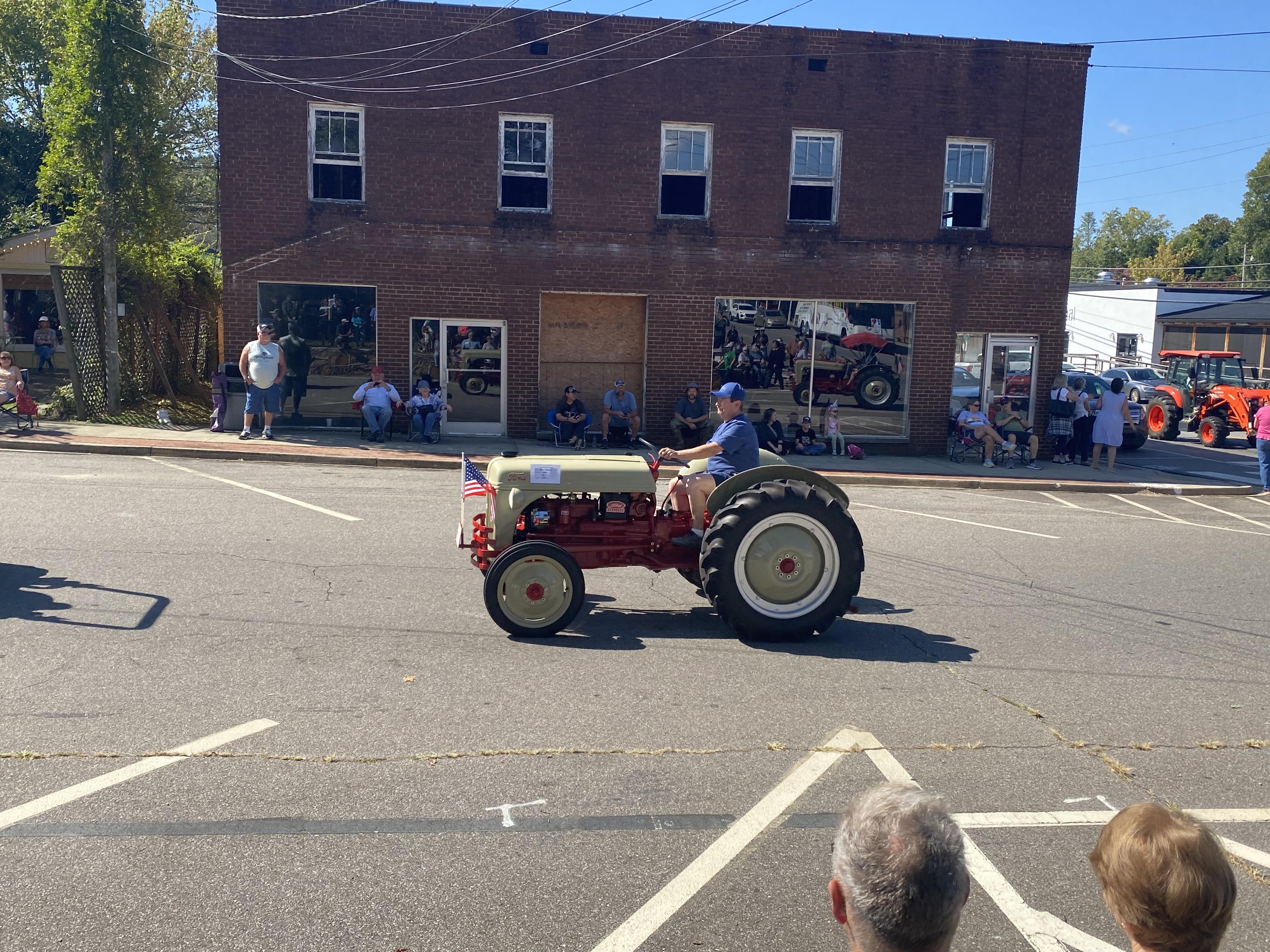 tan and red tractor in parade
