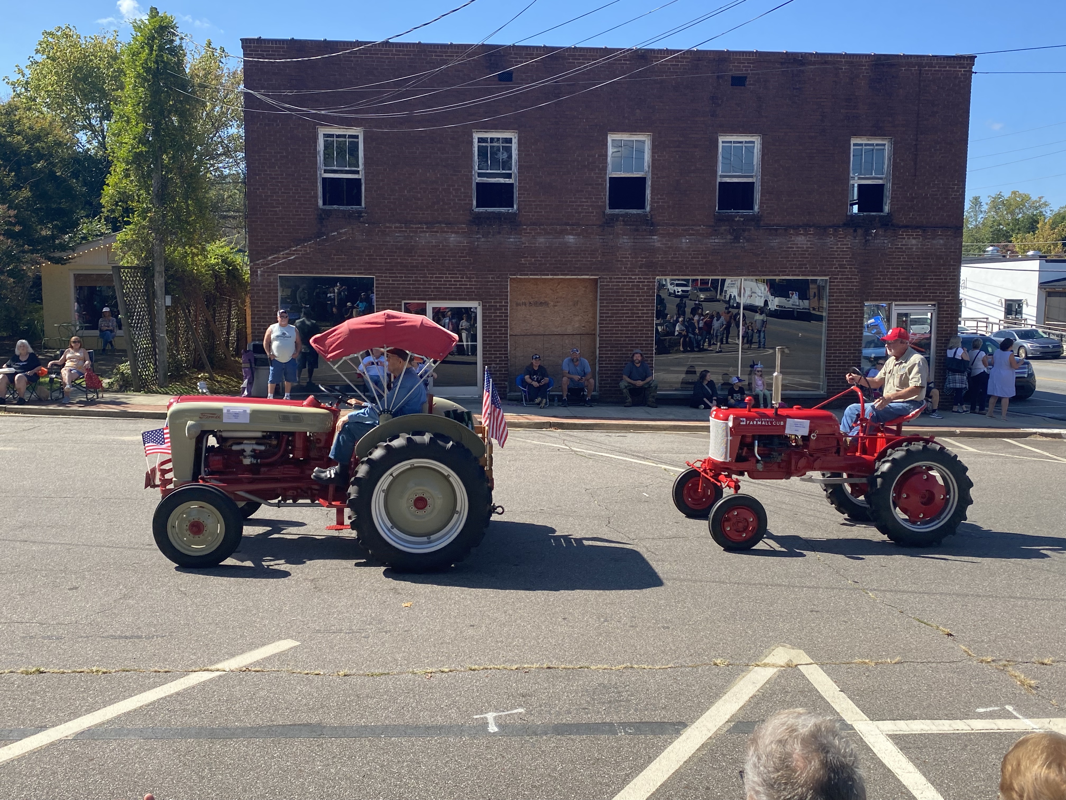 two red tractors in parade