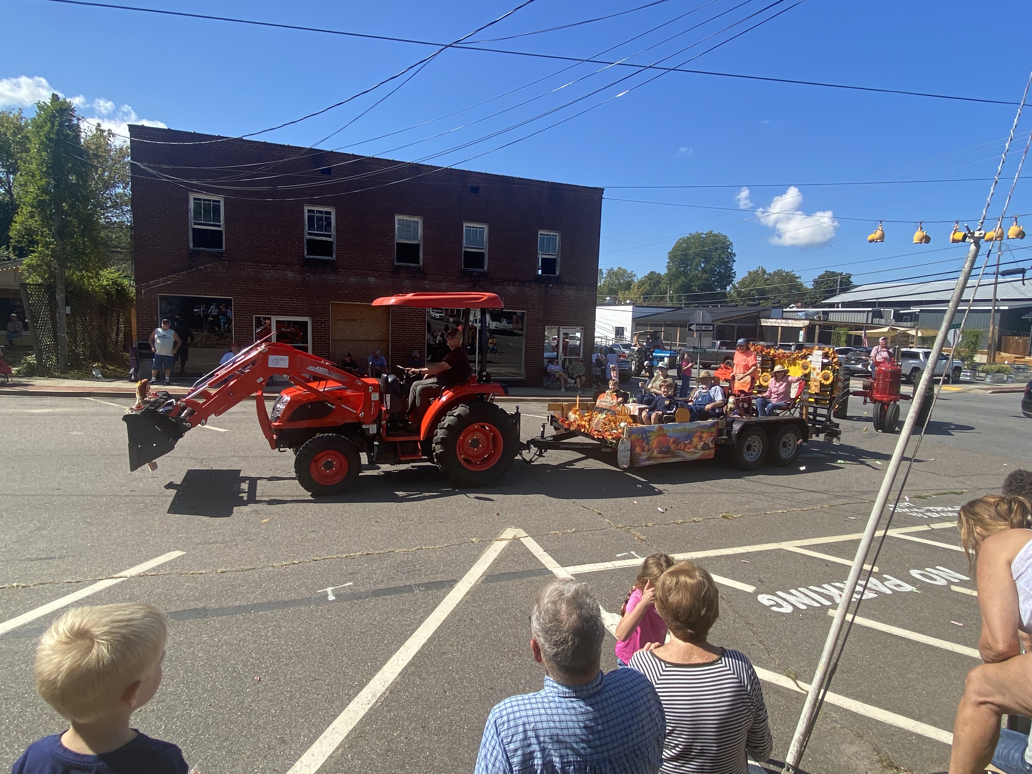 tractor pulling trailer with people in parade