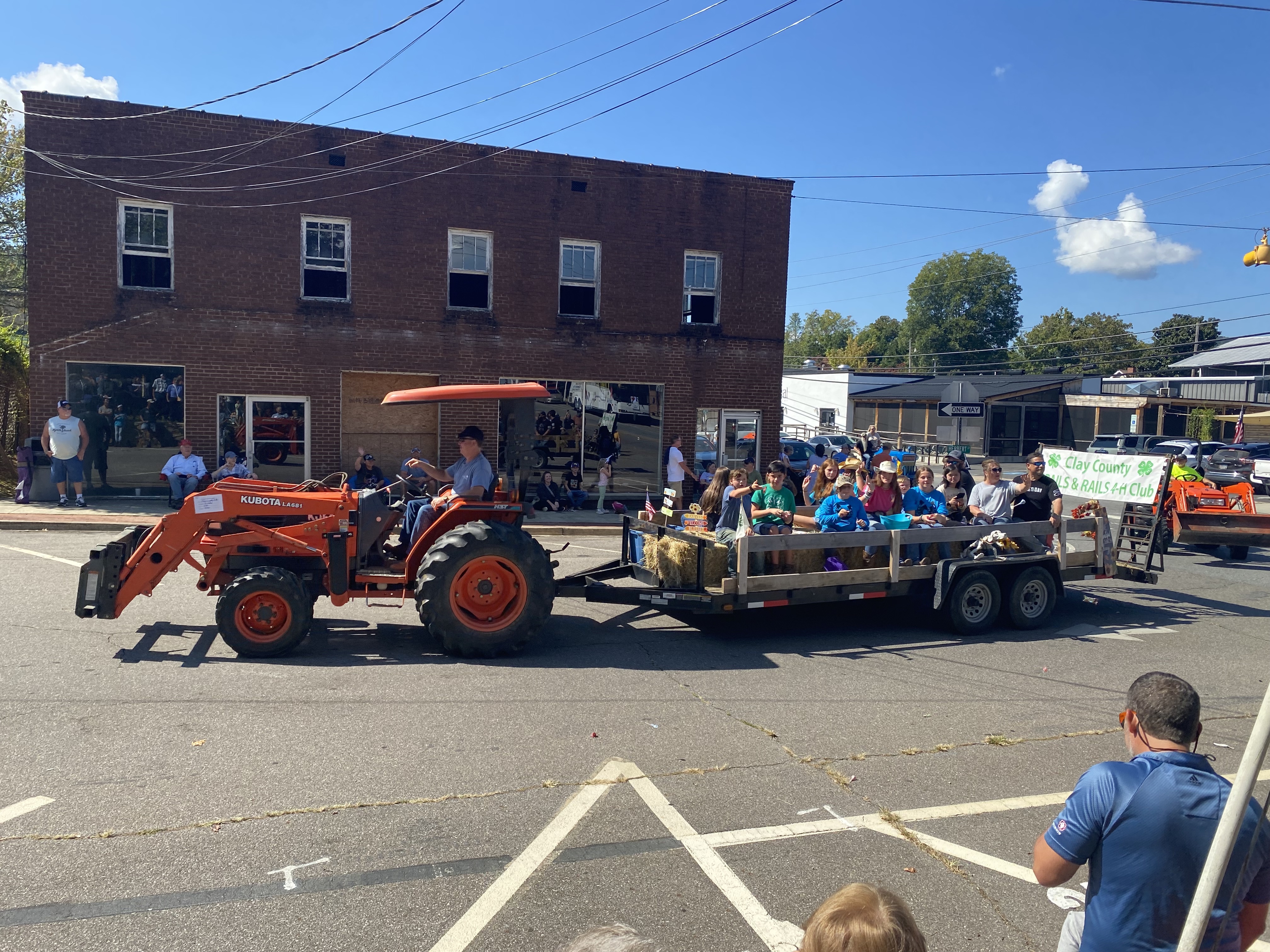 orange tractor with trailer full of people