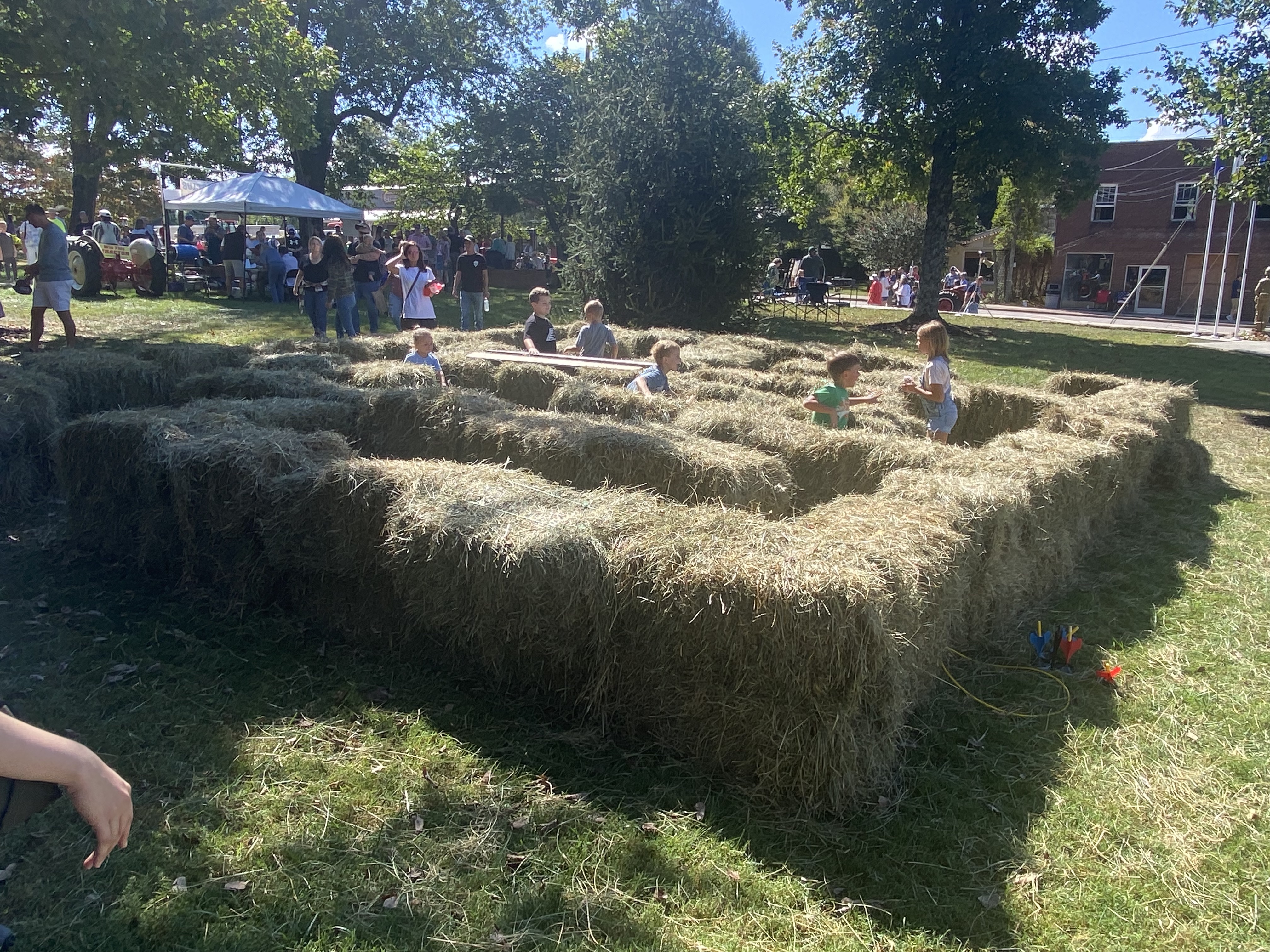 children explore hay bale maze