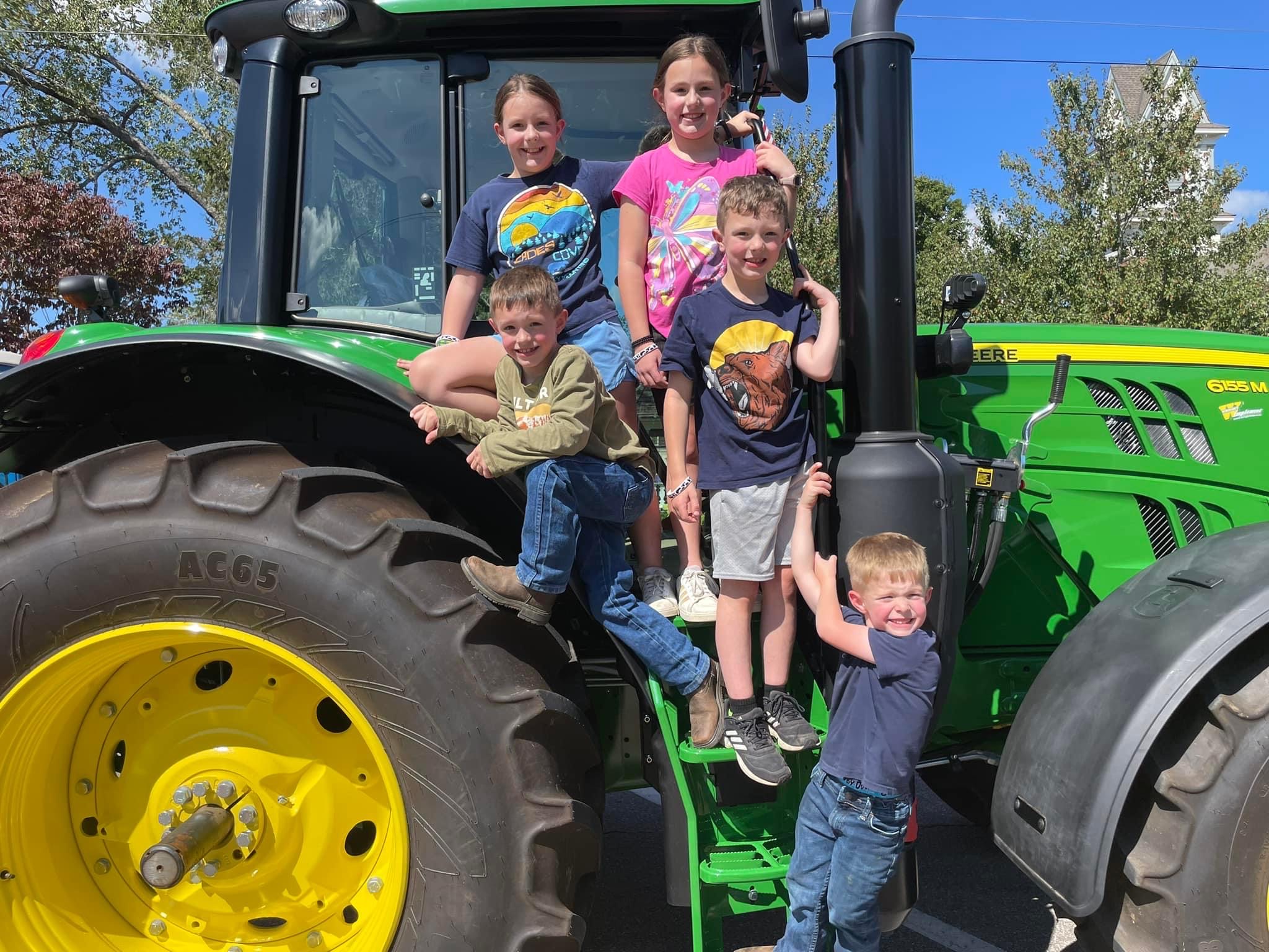 Children pose on John Deere Tractor