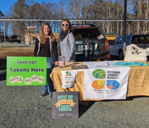 Family & Consumer Sciences Extension Agent Tara Gregory (left) and Pittsboro Farmers' Market Manager Mary Medvar at the Pittsboro Farmers' Market.