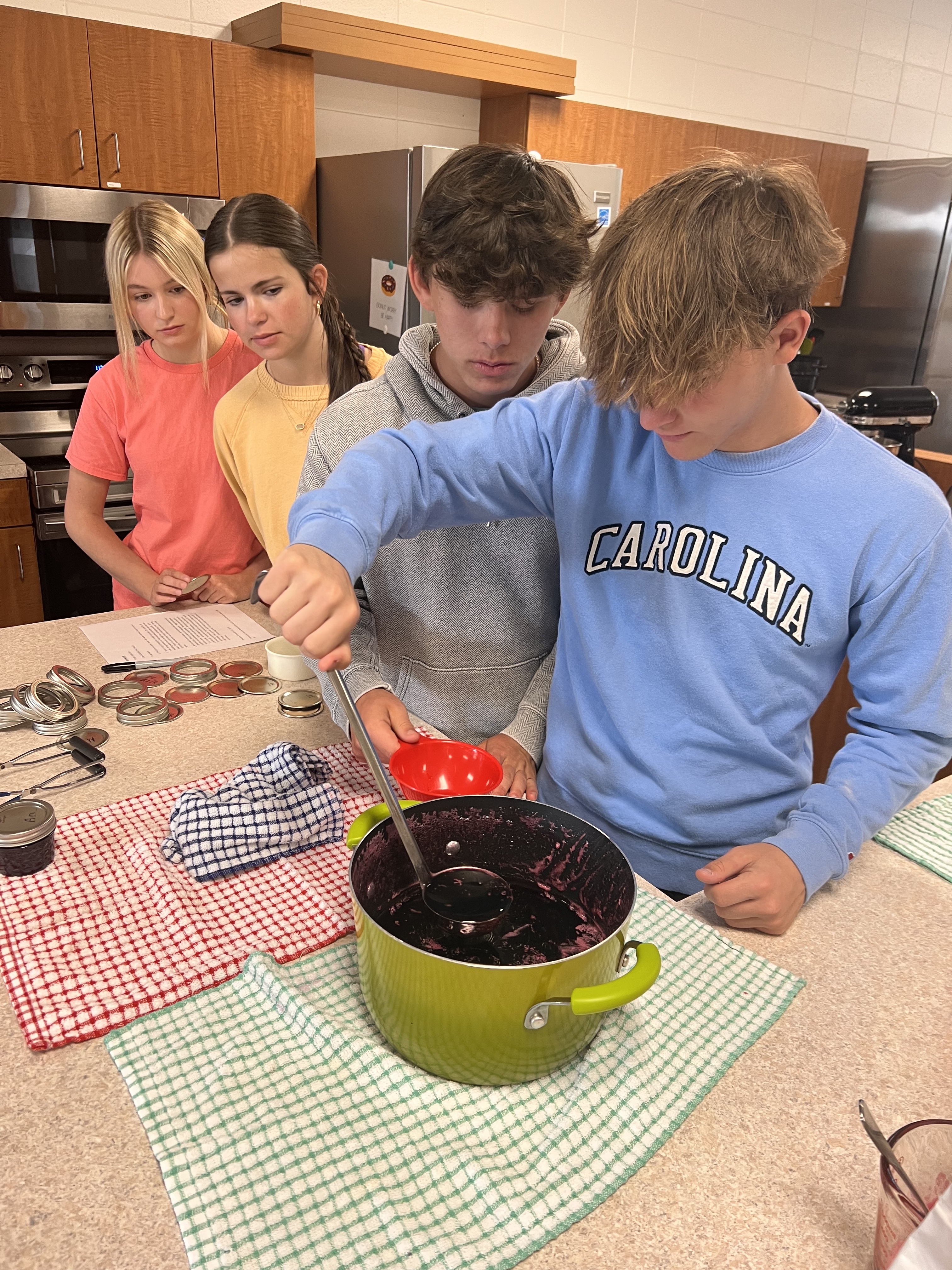 Students preparing grape jelly for canning.